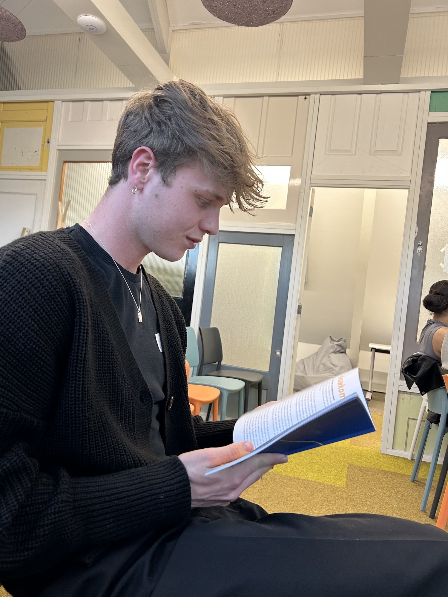 Lars (ervaringsdeskundige van het Regenboogloket) leest de Taalgids van het LAKS
